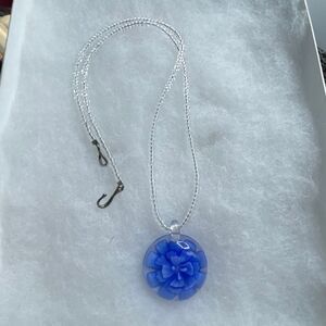Artisan made Lampworked glass blue flower pendant necklace.